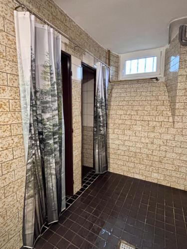 a bathroom with transparent shower curtains in a room at Ubytování Přimda in Přimda