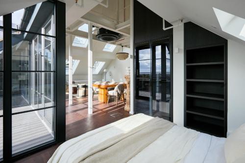 a bedroom with a bed and a large window at The Hill by Nestor in Harrow