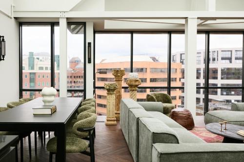 a living room with a couch and chairs and a table at The Hill by Nestor in Harrow