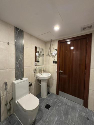 um banheiro com vaso sanitário e pia em سوات للشقق المخدومة 5 em Al Khobar