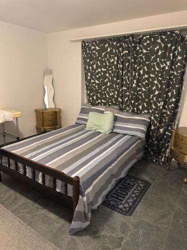 a bedroom with a bed with a black and white headboard at Meri 2 in Ostermundigen