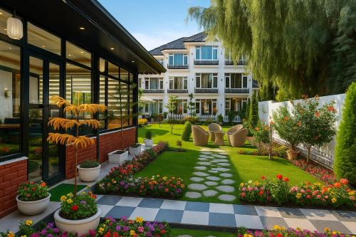 a garden with plants and flowers in front of a building at De Elaaf The Luxury Stay in Srinagar
