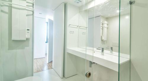 a bathroom with a glass shower and a toilet at Cathedral Design Apartments in Porto