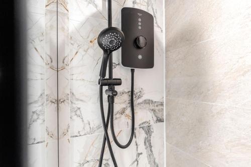 a shower with a blow dryer in a bathroom at Bold St City Centre Freewifi Walk Everywhere in Liverpool