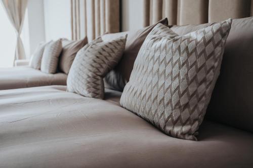 a couch with four pillows on top of it at Bold St City Centre Freewifi Walk Everywhere in Liverpool