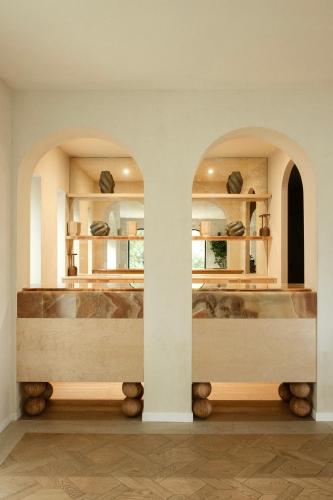 a room with two arches and a table in a building at Maison Provence in Saint-Tropez