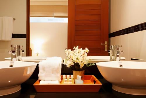 a bathroom with two sinks and a large mirror at 3BR SeaView Villa with Private Pool Kamala Falls in Kamala Beach