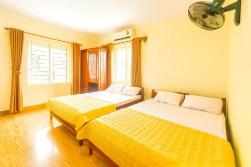 a bedroom with two beds and a window at Trường Sa Hotel Cửa Lò Beach in Cửa Lò
