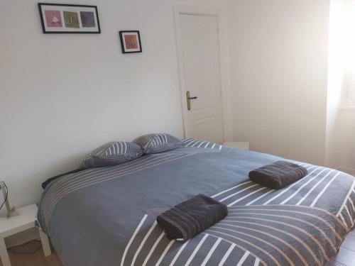 a bedroom with a bed with two pillows on it at Port Rhu Appartement 4 personnes in Douarnenez
