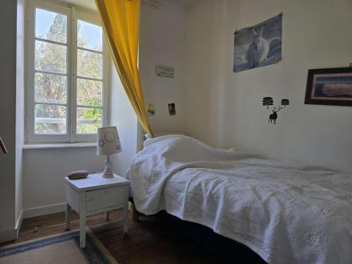 a bedroom with a bed and a window at 751 - Maison de caractère avec magnifique jardin clos in Erquy