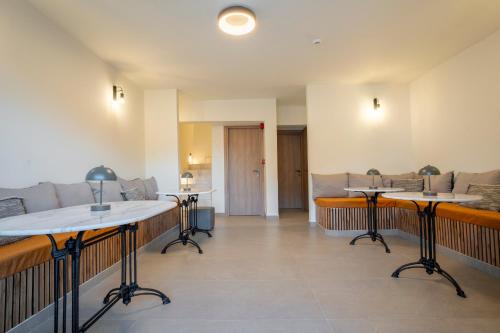 a room with two tables and a couch at Naiades Guest House in Sálakos