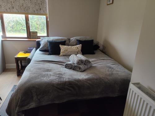 a bed in a bedroom with two towels on it at Tranquil Countryside Escape in Rural Kent- Pipistrelle View in Canterbury