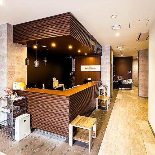 a bar in a restaurant with a counter and chairs at Arigato Stay Kanazawa Ekimae in Kanazawa
