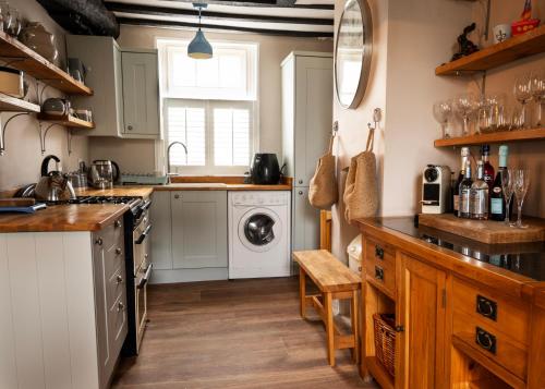 a kitchen with a sink and a washing machine at Old Customs House in Harwich
