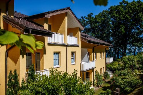a building with balconies on the side of it at Inselhotel Rügen in Göhren
