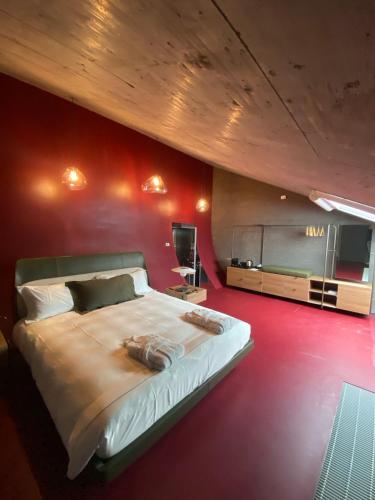 a bedroom with a large bed and a tv at Cantina dei 5 Sogni in Monforte dʼAlba