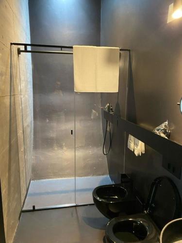 a bathroom with a toilet and a glass shower at Cantina dei 5 Sogni in Monforte dʼAlba