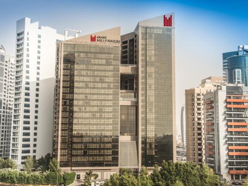 a group of tall buildings in a city at Grand Millennium Dubai in Dubai