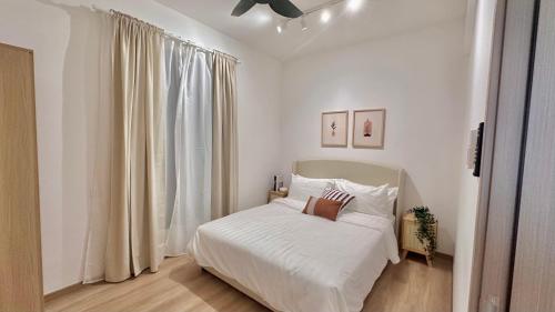 um quarto branco com uma cama e uma janela em Baron Residence by manatidur #PetFriendly #Lakecity em Kuala Lumpur