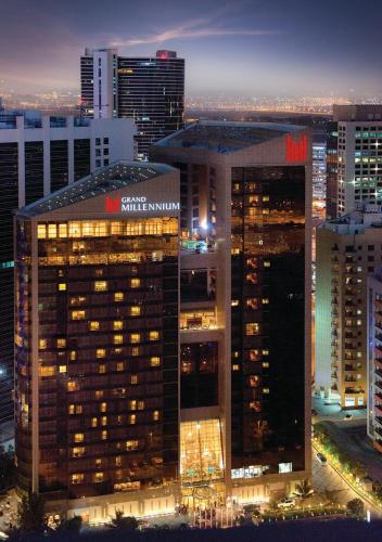 a view of a large building in a city at night at Grand Millennium Dubai in Dubai