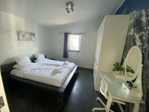 a bedroom with a bed and a sink and a mirror at Bungalow Haarlem Amsterdam with jacuzzi in Vijfhuizen
