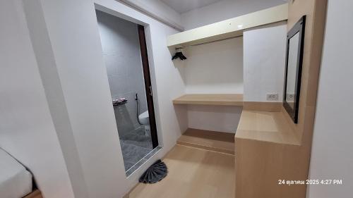a bathroom with a walk in shower and a mirror at Sleep In Lanta Resort in Ko Lanta