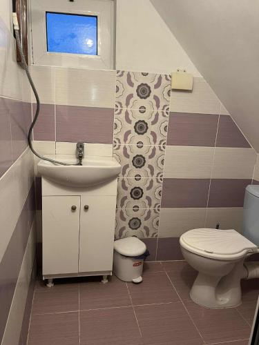 a small bathroom with a sink and a toilet at Country House БатЖоро in Zelenikovo