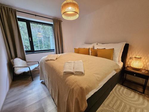 a bedroom with a large bed and a window at Mlýn Herlíkovice in Hořejší Vrchlabí