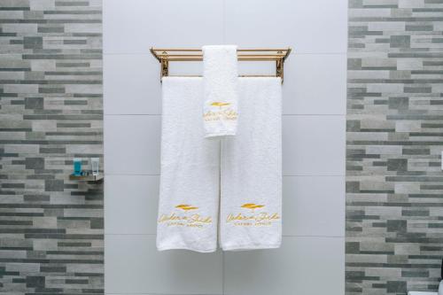 two towels on a towel rack in a bathroom at Under The Shade Safari Lodge in Arusha