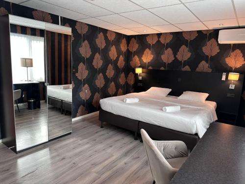 a hotel room with a bed and a dining table at Westlake Hotels Amsterdam in Amsterdam