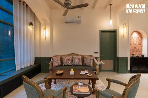 a living room with a couch and a table at StayVista at Raga Living - Mountain Views, Bonfire in Parwanoo