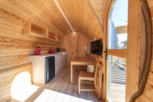 a kitchen in a tiny house with a window at Wellnes Hříbek in Dyjákovice