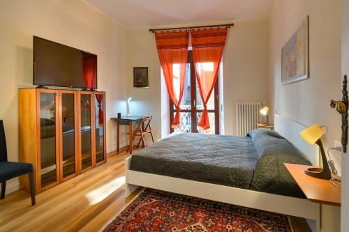 a bedroom with a bed and a flat screen tv at Residenza La Donzella - Appartamento rosso in Campobasso