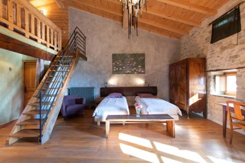 a bedroom with a bed and a staircase in a room at Les Nuits du Taris in Bourdeaux