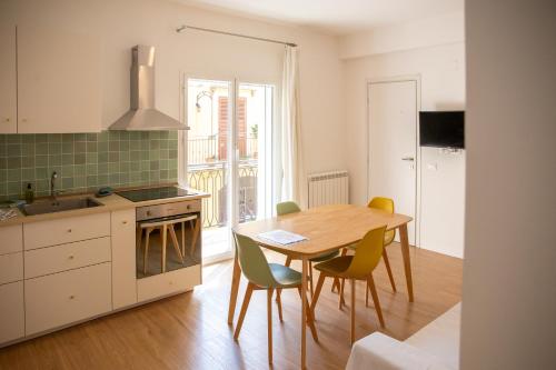 a kitchen with a table and chairs and a dining room at Solemar Sicilia - Casa Minerva in Santa Flavia