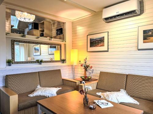 a living room with two couches and a table at Holiday Home Seesicht-Dorf 1 - Haus 11 by Interhome in Reimboldshausen