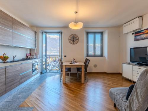 a kitchen and dining room with a table in a room at Apartment Blue Lake by Interhome in Bellano
