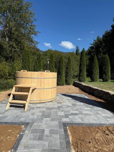 a wooden bench sitting on top of a patio at Aleu - Apuseni Mountains in Pietroasa