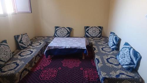 a room with a table and two chairs and a table and chairsuggest at Casa caram in Adrouine