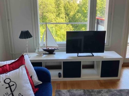 a living room with a tv sitting on a table at Beautiful studio with sauna, balcony in Rauma
