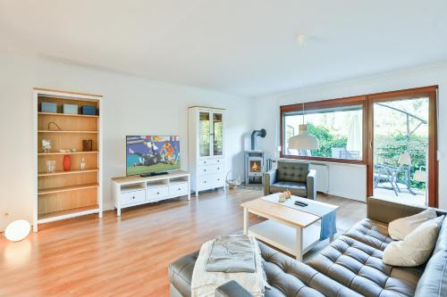 a living room with a couch and a table at Ferienhaus Heideweg in Zingst