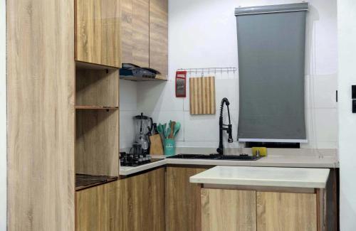 a kitchen with wooden cabinets and a sink at Rhema Apartments in Lagos