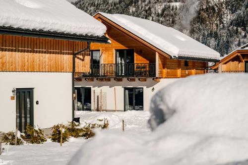 a house covered in snow in front at Clofers Relax Residences Rattendorf in Rattendorf