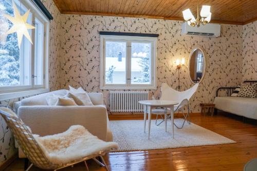 a living room with a couch and a table at Arctic Garden Design Villa in Rovaniemi