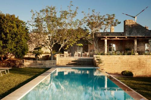 a swimming pool in the yard of a house at Masseria del Gigante in Carpignano Salentino