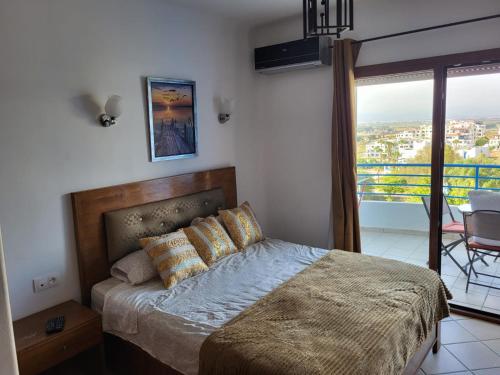 a bedroom with a bed with a view of a city at Cabo dream in Cabo Negro