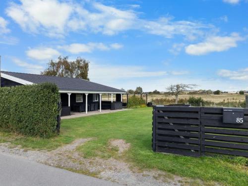 a house with a fence in front of it at Holiday Home Rolfkarl - 250m from the sea by Interhome in Dalby