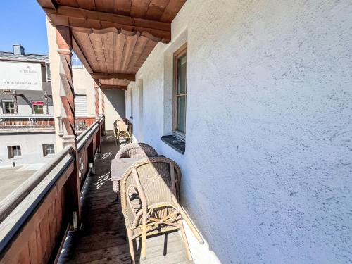 a balcony with two benches on a building at Apartment Cheeky Apartment-4 by Interhome in Oberndorf in Tirol