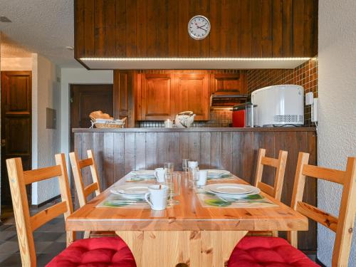a wooden table with chairs in a kitchen with a tableablish at Apartment Centaure B 103 by Interhome in Ovronnaz