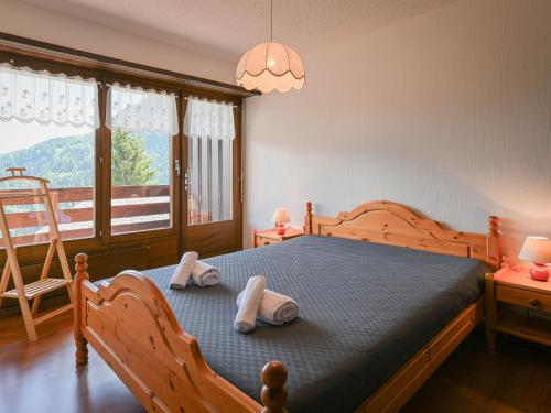 a bedroom with a bed with two towels on it at Apartment Centaure B 103 by Interhome in Ovronnaz